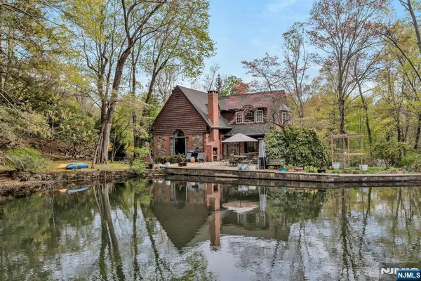 a front view of a house with fountain and porch