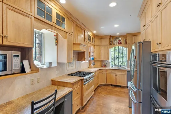 a kitchen with granite countertop a sink stove and cabinets