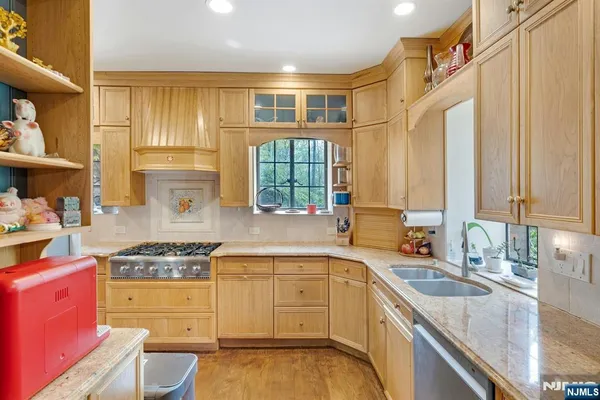 a kitchen with a sink and chairs