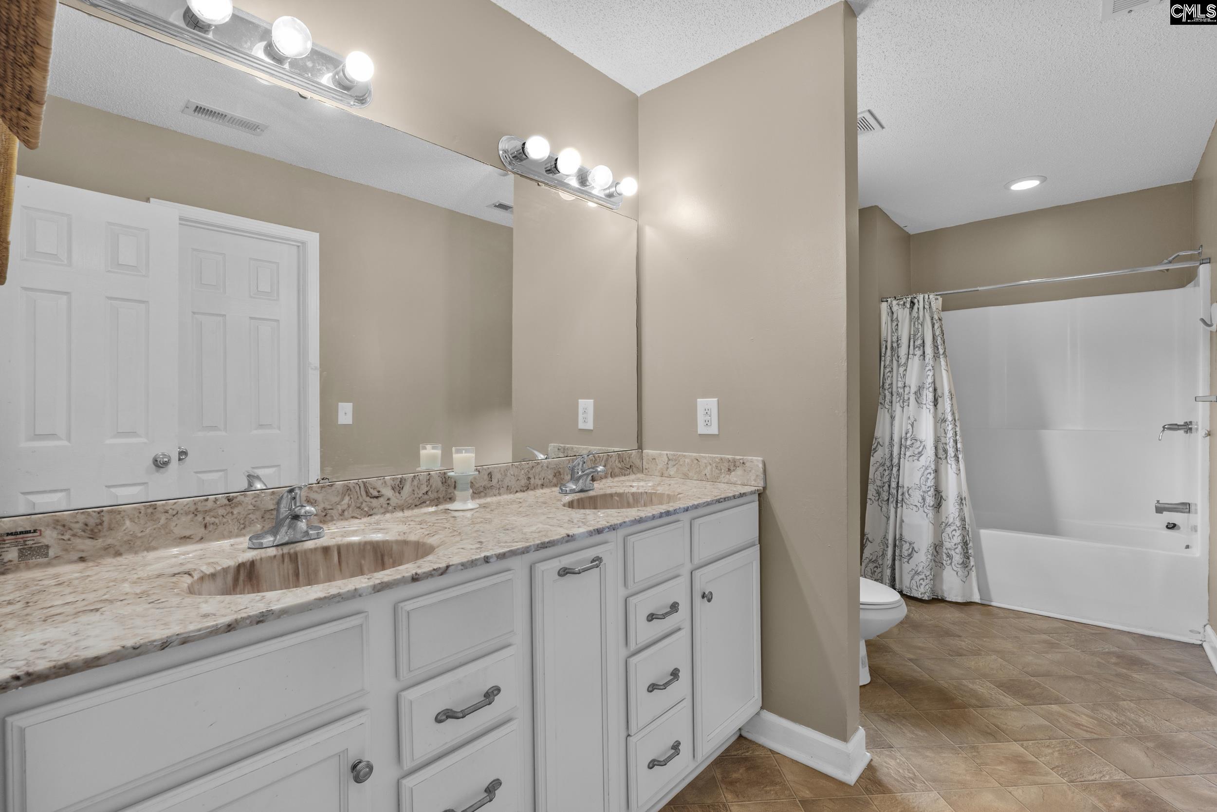 548 Eskie Dixon Road Elgin, SC 29045 - Photo 14 of 27 a bathroom with double sink and a mirror