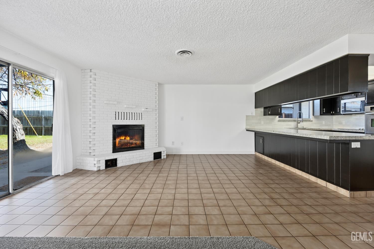 Undisclosed Address Bakersfield, CA 93312 - Photo 13 of 30 a view of empty room with a fireplace and window