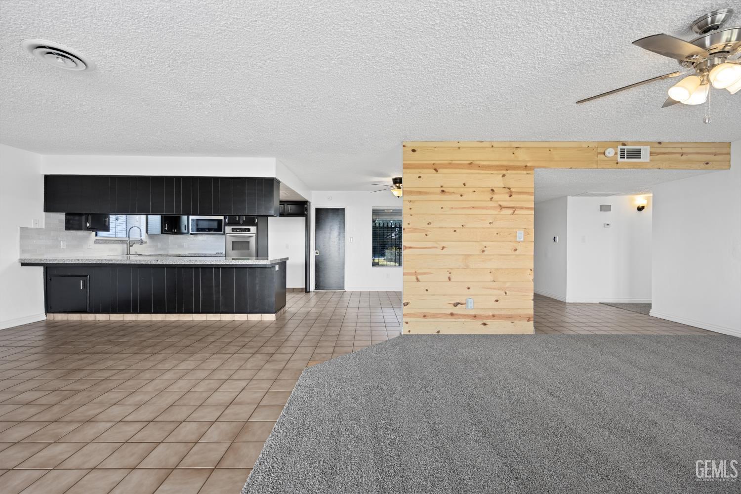 Undisclosed Address Bakersfield, CA 93312 - Photo 16 of 30 a view of kitchen with cabinets and wooden floor