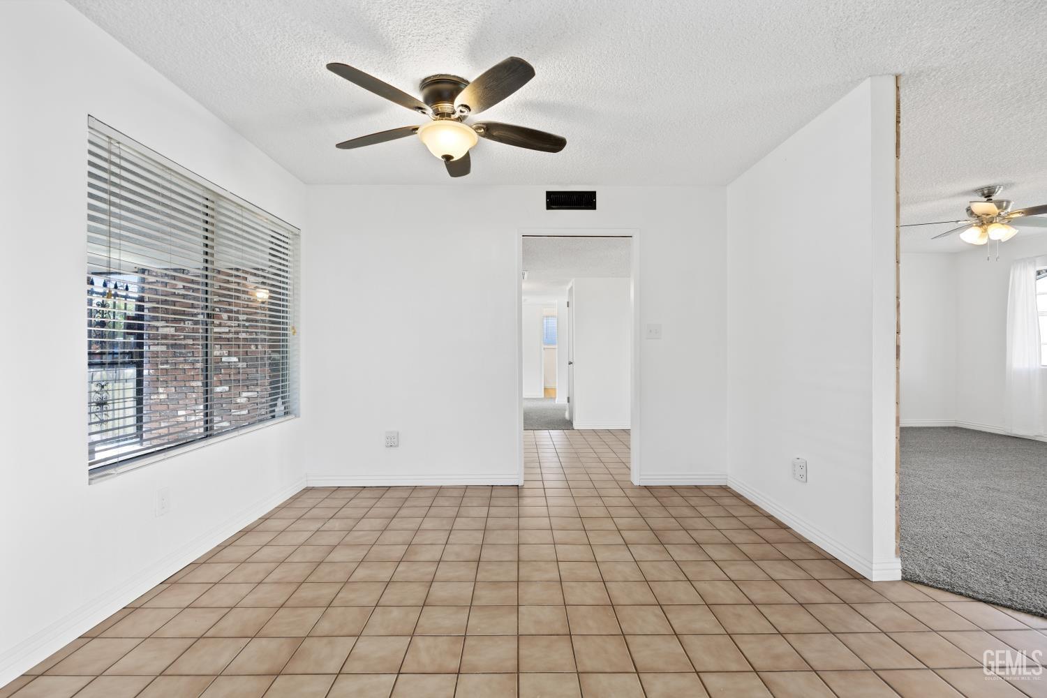 Undisclosed Address Bakersfield, CA 93312 - Photo 17 of 30 an empty room with windows and fan