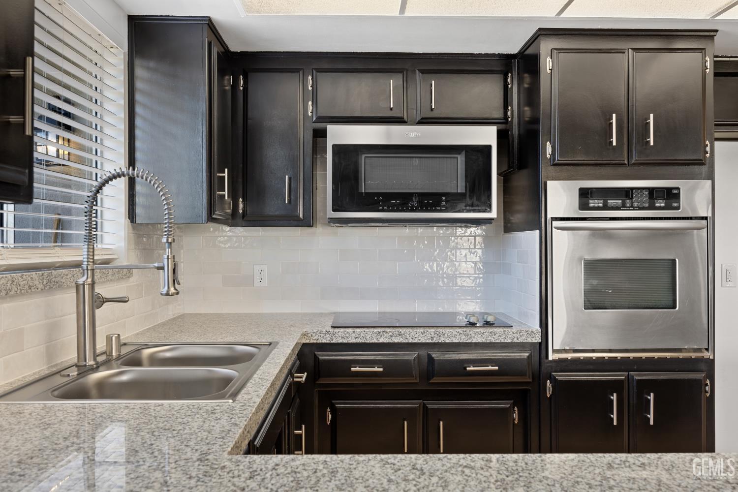 Undisclosed Address Bakersfield, CA 93312 - Photo 20 of 30 a kitchen with granite countertop a stove and a sink