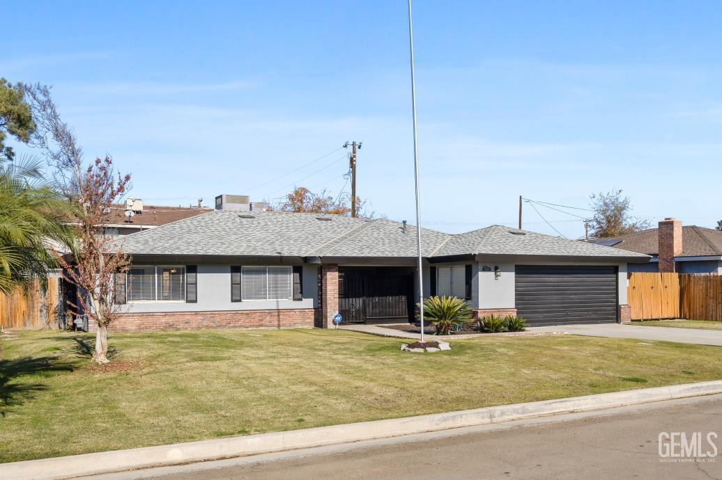 Undisclosed Address Bakersfield, CA 93312 - Photo 2 of 30 a front view of a house with a garden