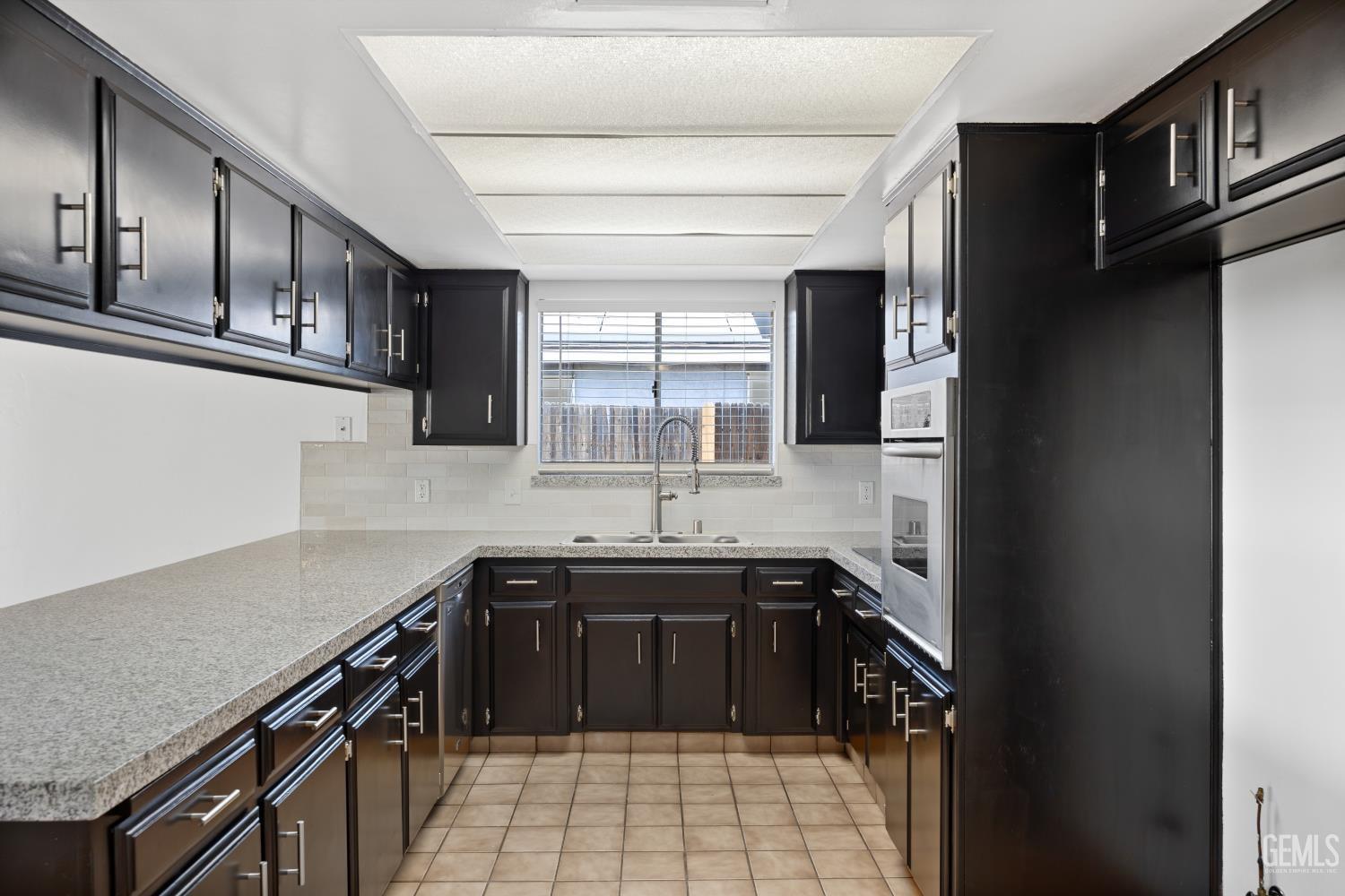 Undisclosed Address Bakersfield, CA 93312 - Photo 21 of 30 a kitchen with stainless steel appliances granite countertop a sink stove and cabinets