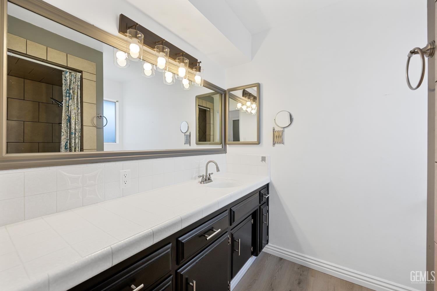 Undisclosed Address Bakersfield, CA 93312 - Photo 25 of 30 a bathroom with a sink and a mirror