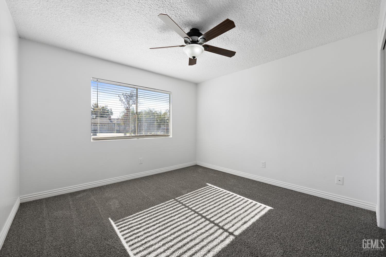 Undisclosed Address Bakersfield, CA 93312 - Photo 26 of 30 an empty room with wooden floor ceiling fan and windows