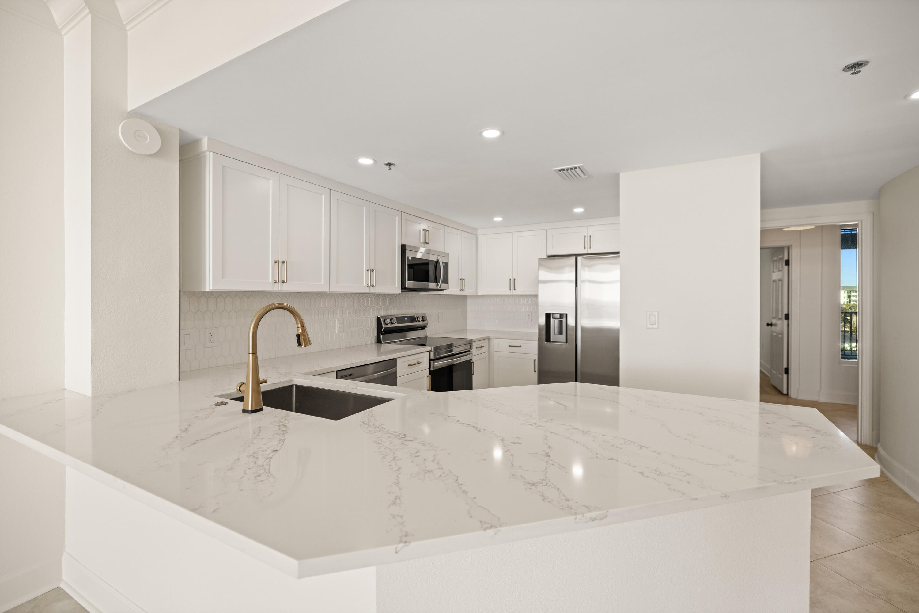 1018 Highway 98, Unit 340 Destin, FL 32541 - Photo 16 of 62 a large white kitchen with stainless steel appliances