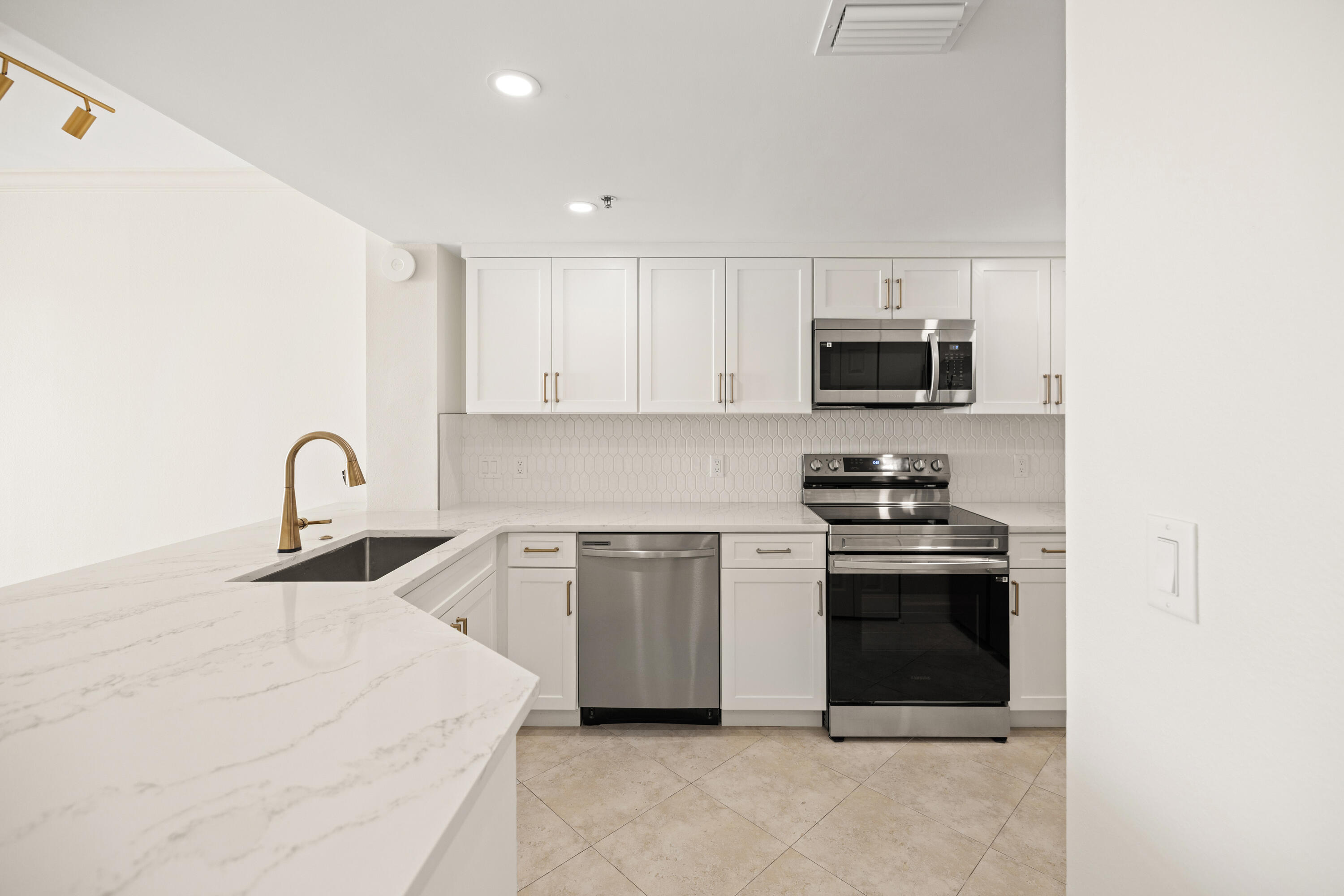 1018 Highway 98, Unit 340 Destin, FL 32541 - Photo 18 of 62 a kitchen with stainless steel appliances granite countertop a stove a sink and a microwave