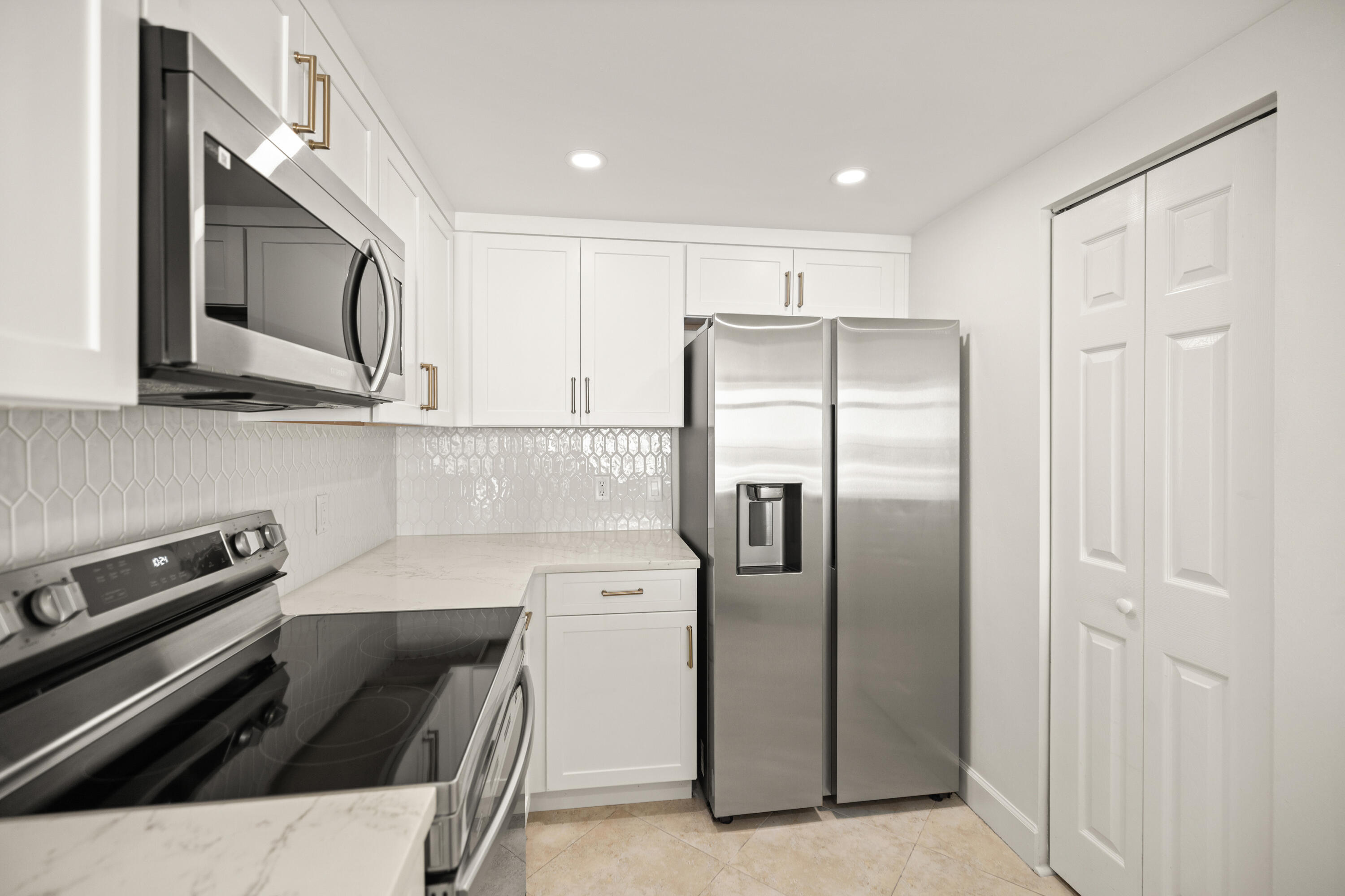1018 Highway 98, Unit 340 Destin, FL 32541 - Photo 20 of 62 a kitchen with stainless steel appliances granite countertop a refrigerator and a stove top oven