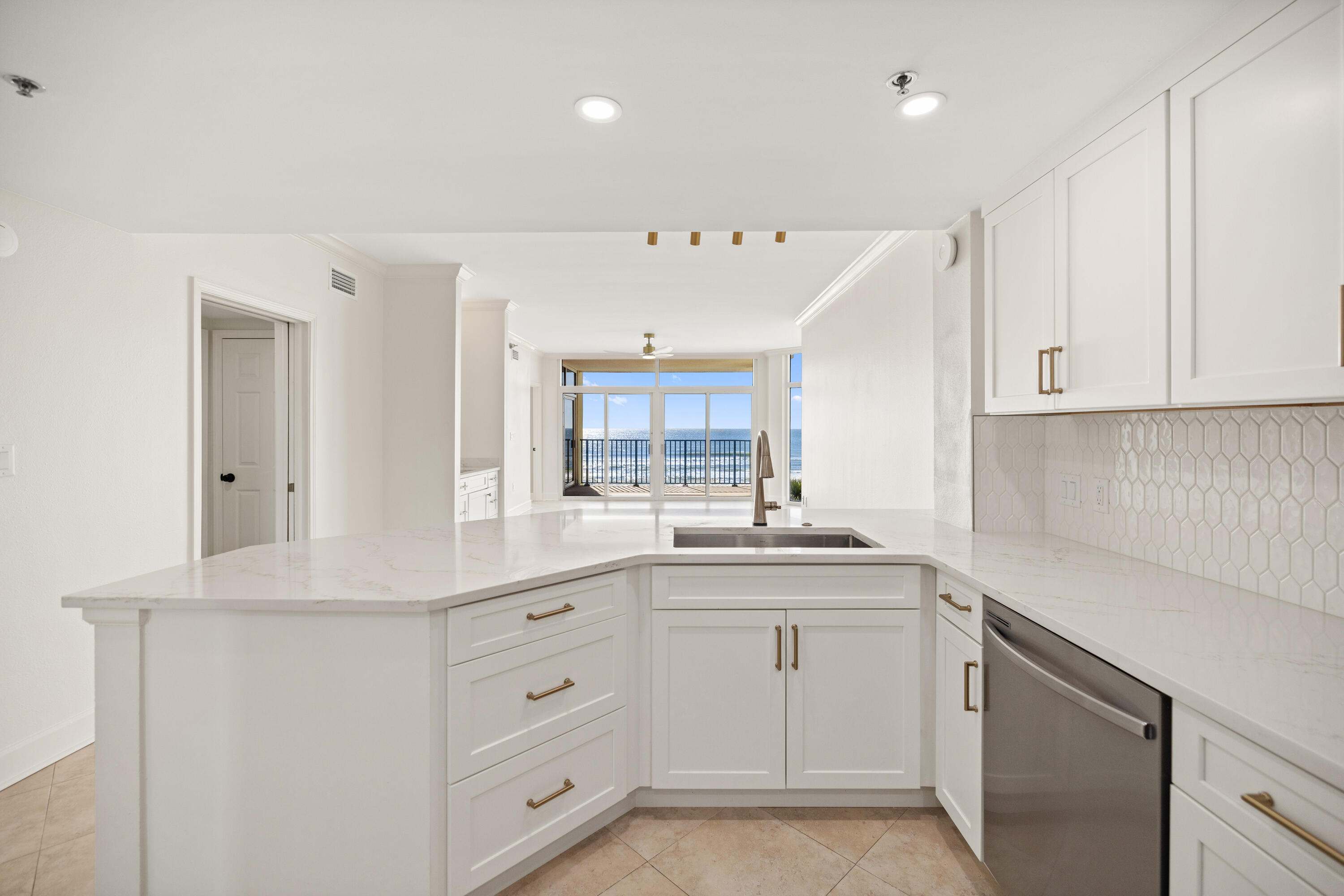 1018 Highway 98, Unit 340 Destin, FL 32541 - Photo 22 of 62 a kitchen with white cabinets and sink