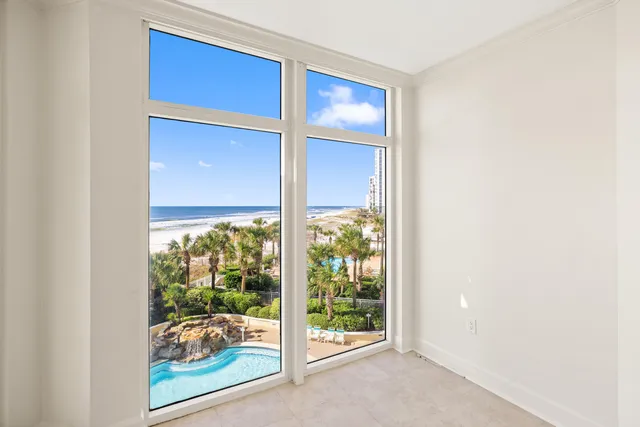 a view of a floor to ceiling window with a kitchen