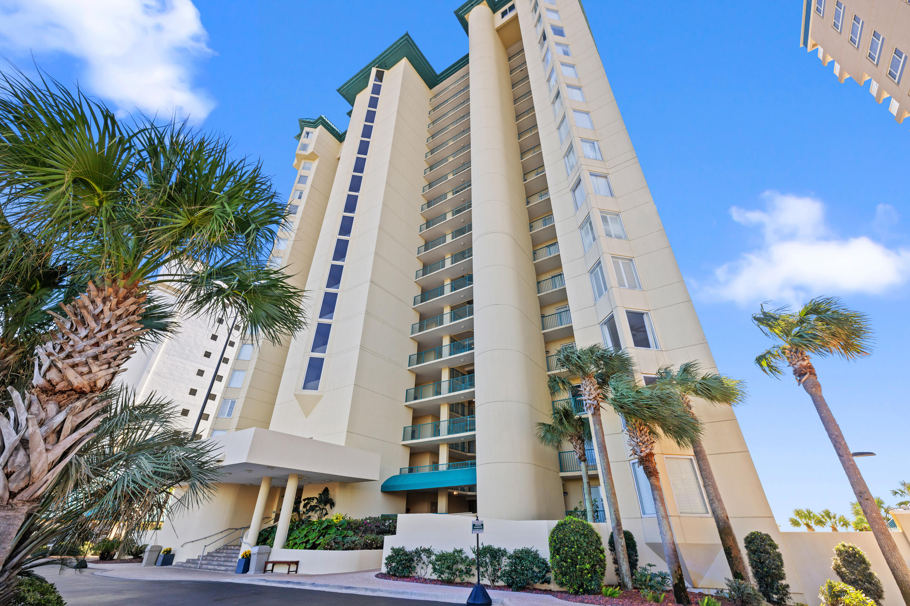 1018 Highway 98, Unit 340 Destin, FL 32541 - Photo 47 of 62 a front view of multi story residential apartment building with yard and entryway