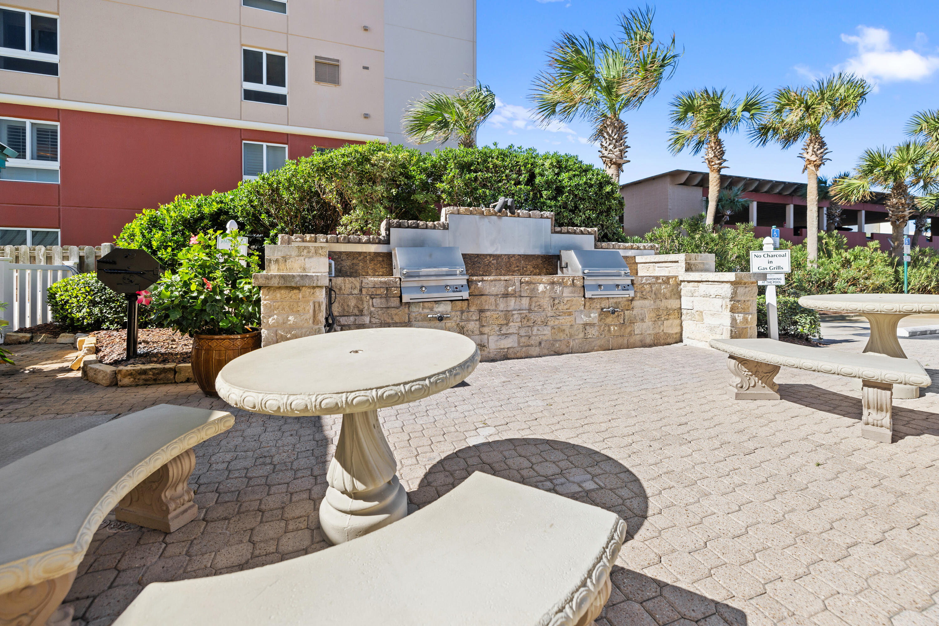 1018 Highway 98, Unit 340 Destin, FL 32541 - Photo 60 of 62 a view of a chairs and table in backyard