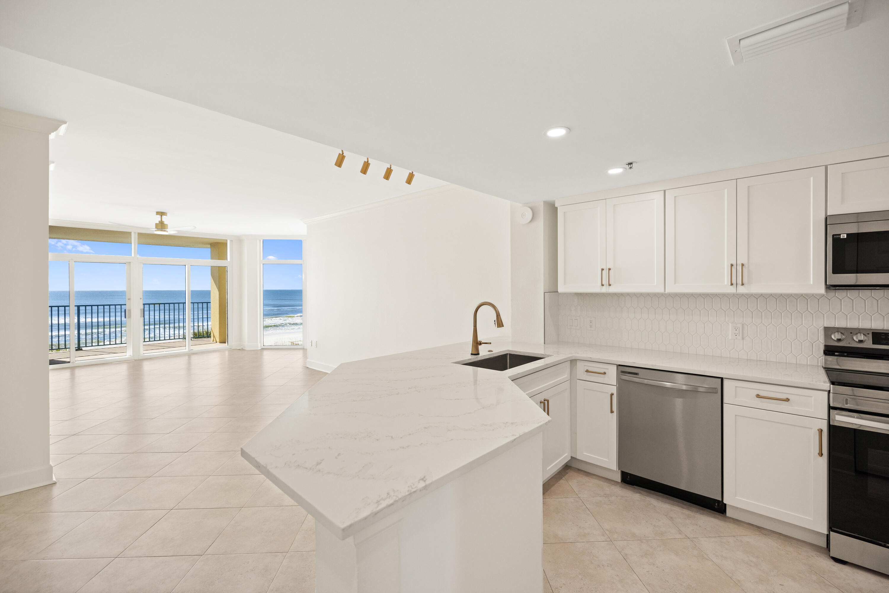 1018 Highway 98, Unit 340 Destin, FL 32541 - Photo 8 of 62 a kitchen with stainless steel appliances a stove a sink a oven and cabinets