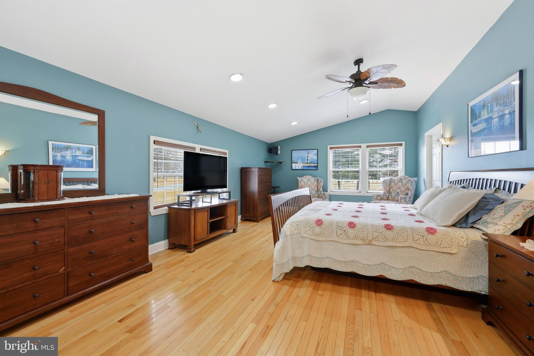 319 Wye Road Queenstown, MD 21658 - Photo 18 of 29 a bedroom with a large bed a flat tv screen and a dresser