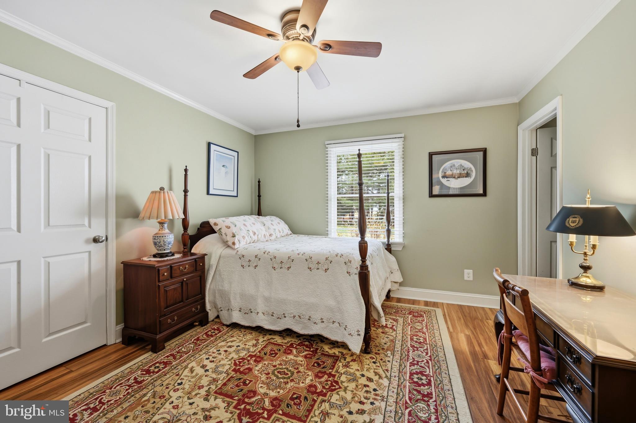 319 Wye Road Queenstown, MD 21658 - Photo 20 of 29 a bedroom with a bed and a chandelier