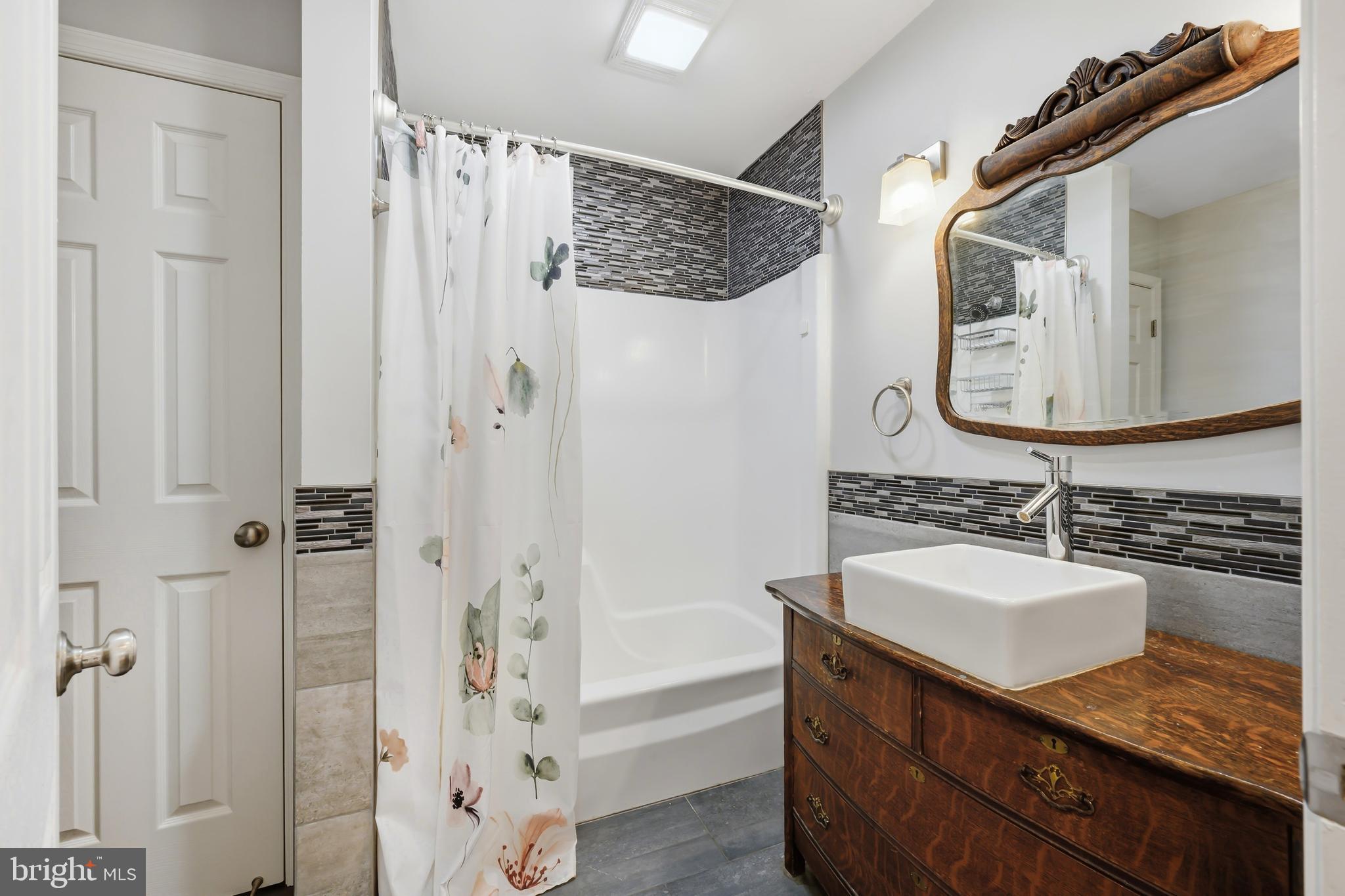 319 Wye Road Queenstown, MD 21658 - Photo 22 of 29 a bathroom with a sink a mirror and a shower