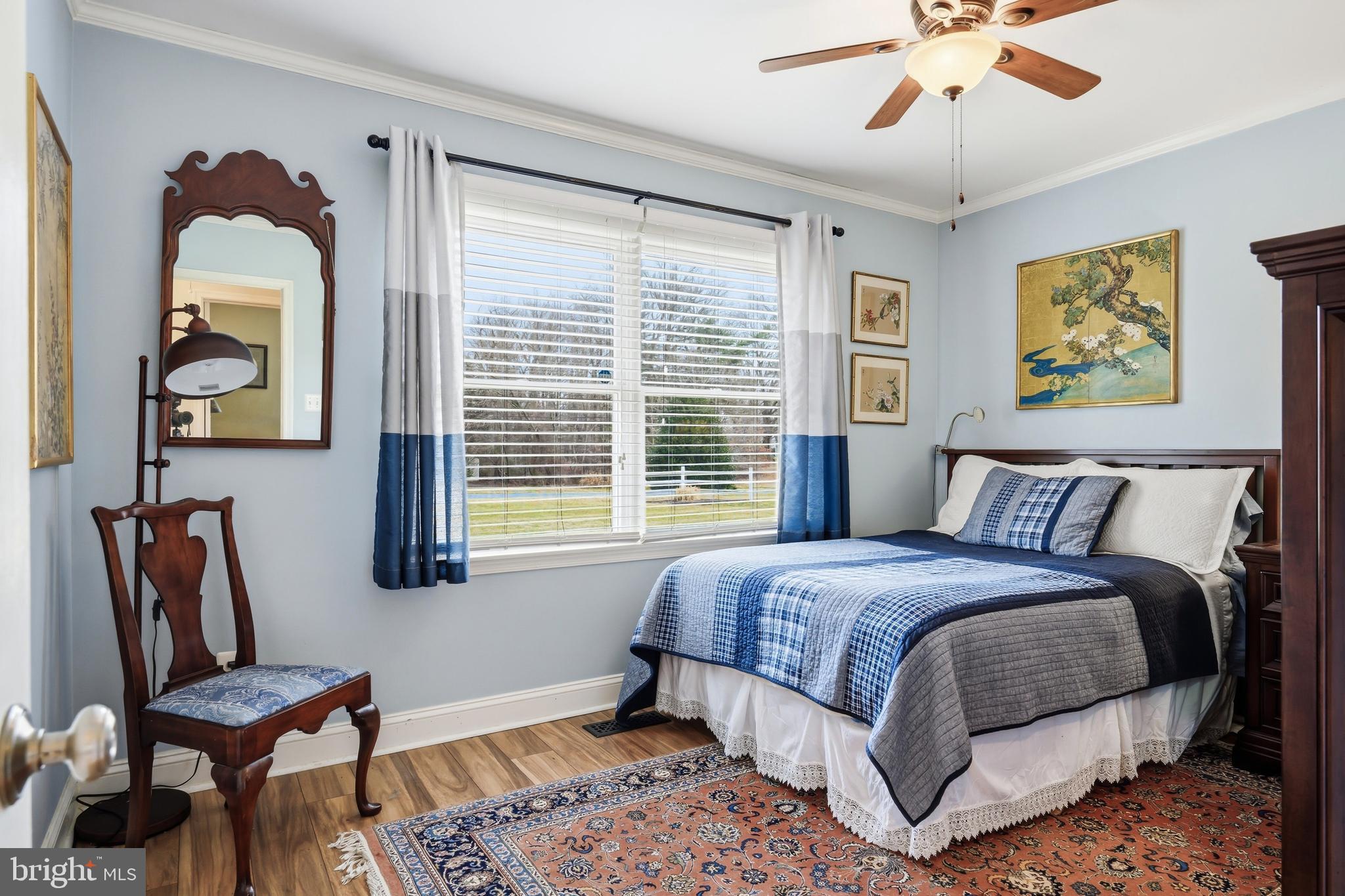 319 Wye Road Queenstown, MD 21658 - Photo 23 of 29 a bedroom with a bed and wooden floor