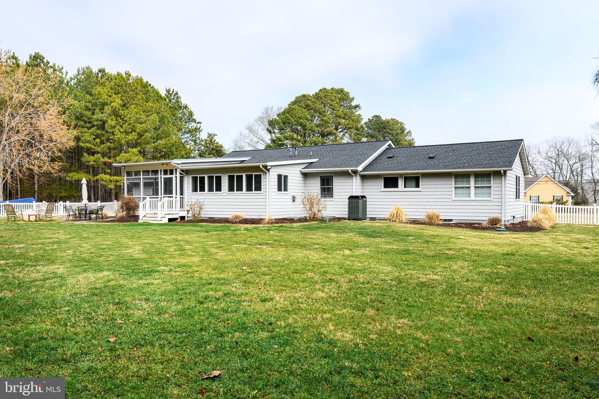319 Wye Road Queenstown, MD 21658 - Photo 26 of 29 a front view of a house with a yard table and chairs
