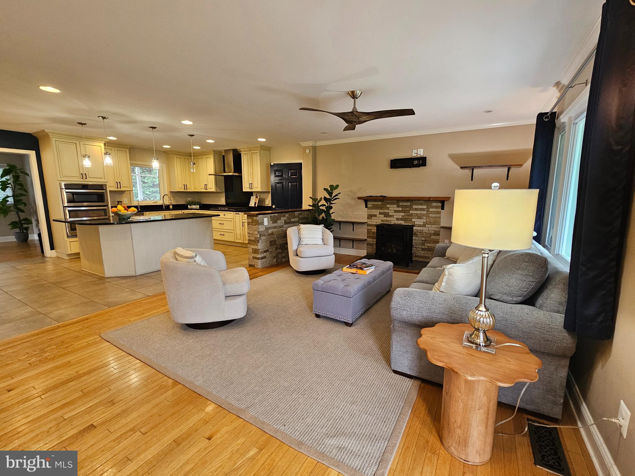 319 Wye Road Queenstown, MD 21658 - Photo 8 of 29 a living room with fireplace furniture and a flat screen tv