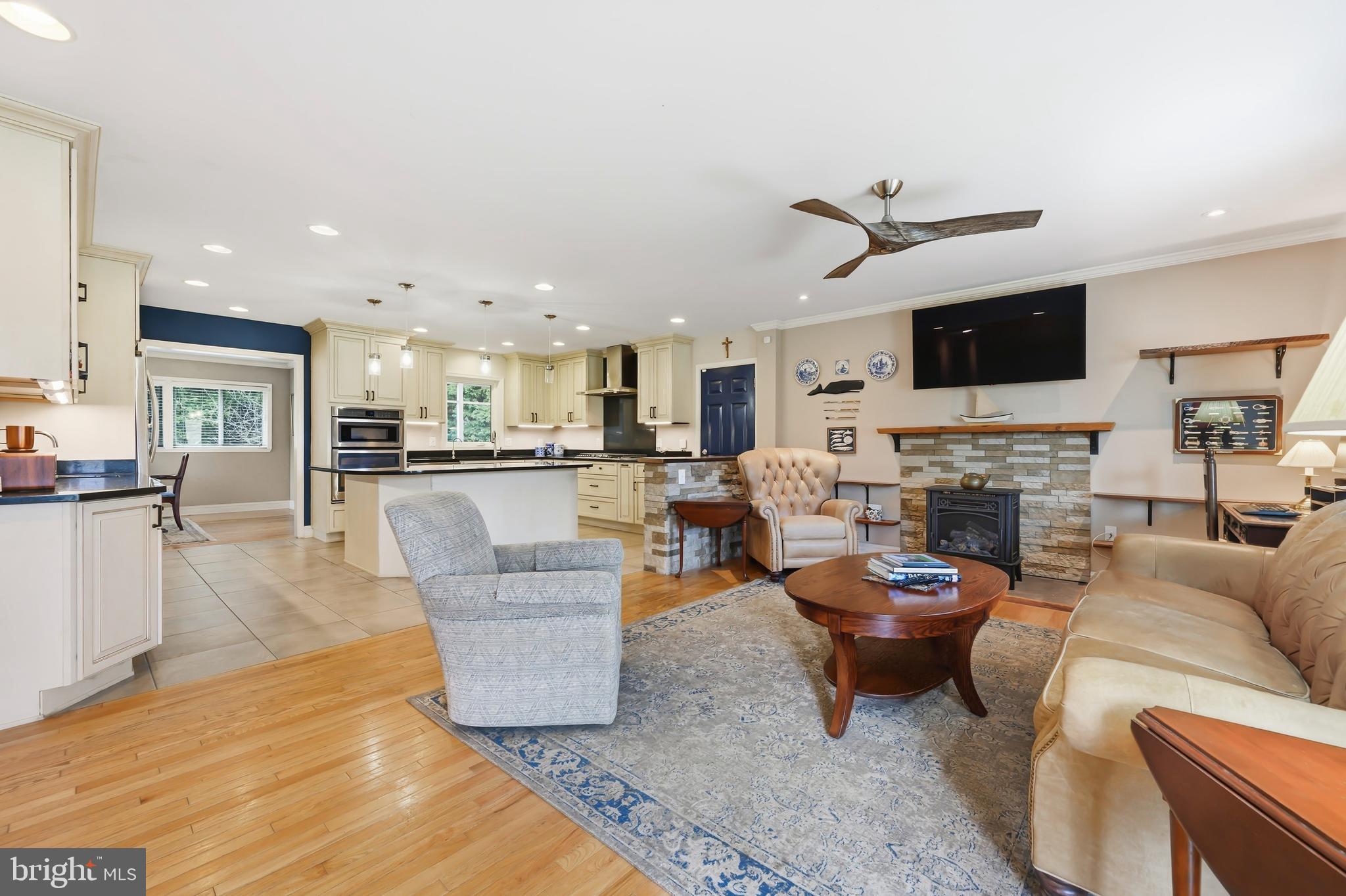 319 Wye Road Queenstown, MD 21658 - Photo 8 of 29 a living room with furniture a fireplace and a flat screen tv