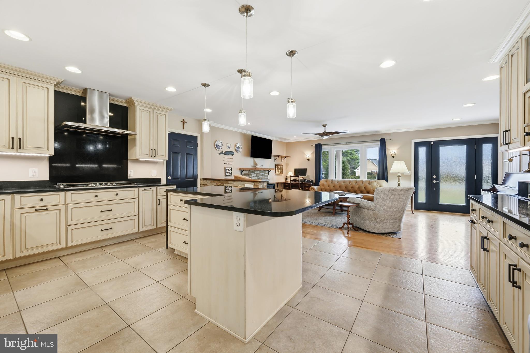 319 Wye Road Queenstown, MD 21658 - Photo 10 of 29 a kitchen with stainless steel appliances kitchen island granite countertop a refrigerator and microwave