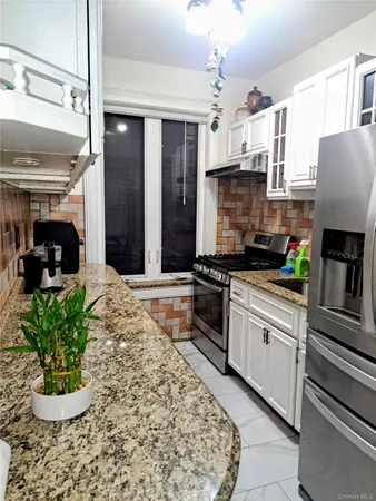 a kitchen with a stove a sink and a refrigerator