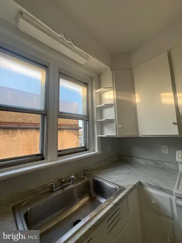 a kitchen that has a sink and a stove