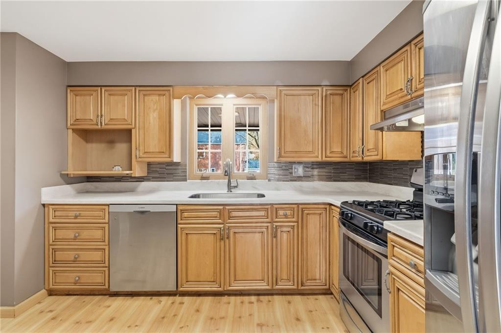 419 Burlington Road Pittsburgh, PA 15221 - Photo 11 of 38 a kitchen with stainless steel appliances granite countertop a stove a sink and a microwave