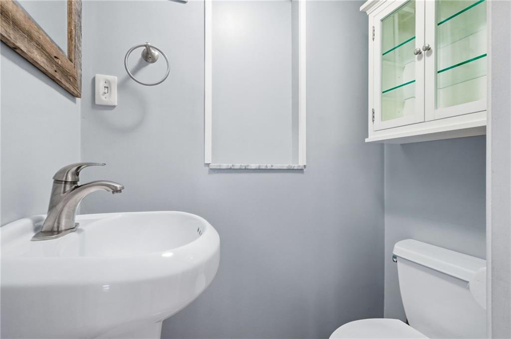 419 Burlington Road Pittsburgh, PA 15221 - Photo 17 of 38 a bathroom with a sink a toilet and a mirror