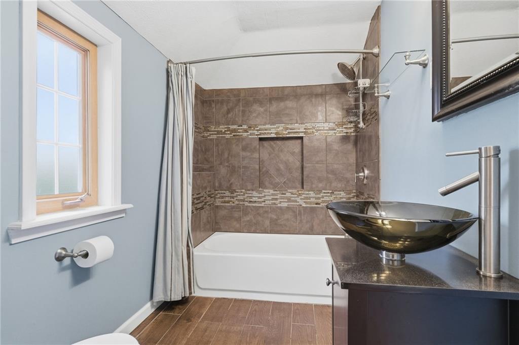 419 Burlington Road Pittsburgh, PA 15221 - Photo 25 of 38 a bathroom with a sink and a mirror