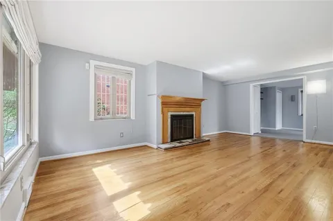 wooden floor fireplace and natural light in room