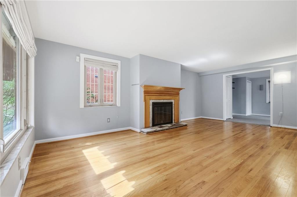 419 Burlington Road Pittsburgh, PA 15221 - Photo 4 of 38 a view of empty room with wooden floor and fireplace
