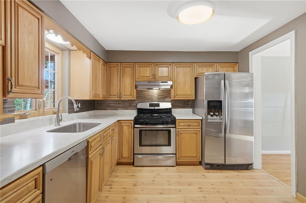 419 Burlington Road Pittsburgh, PA 15221 - Photo 10 of 38 a kitchen with a stove a refrigerator and a sink