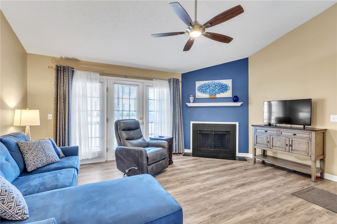 706 Pelham Square Way Greer, SC 29650 - Photo 2 of 20 This bright living space features elegant French doors, a cozy fireplace, and durable wood flooring.
