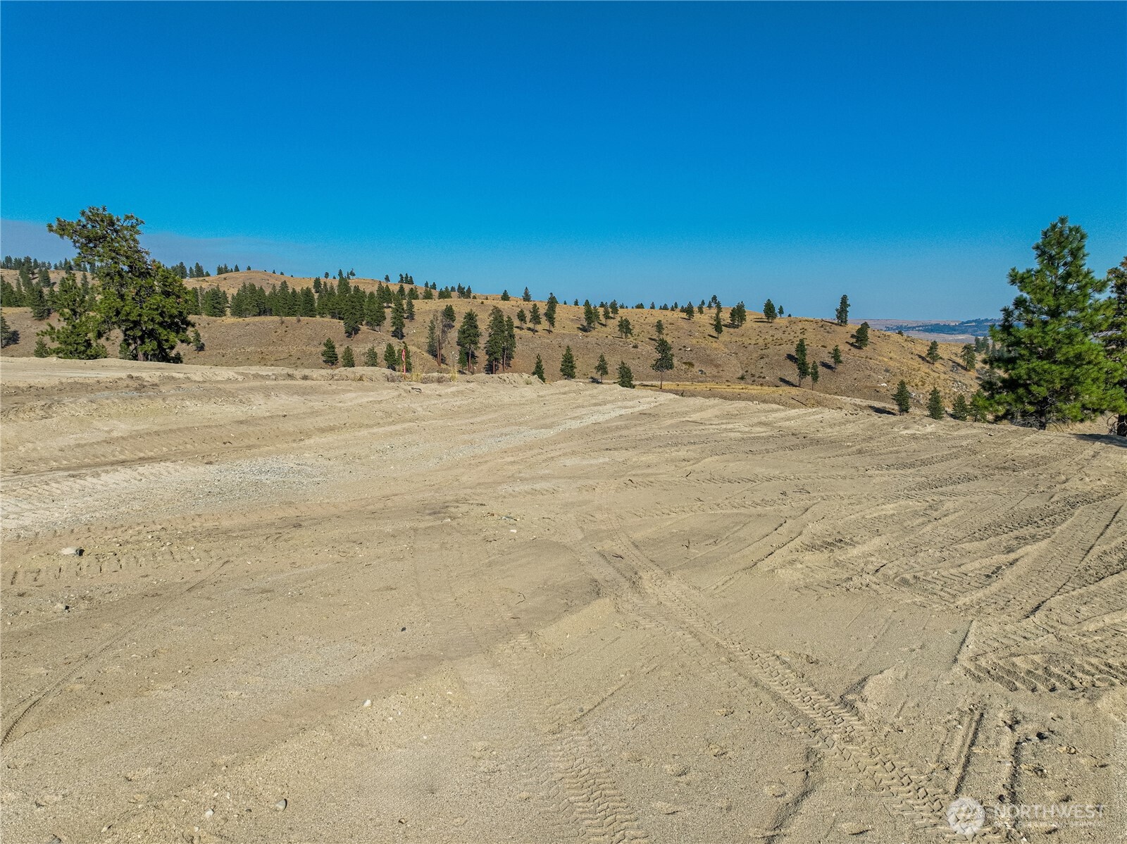 0 Evergreen Camp Road Chelan, WA 98816 - Photo 10 of 21 a view of a dry yard with wooden fence