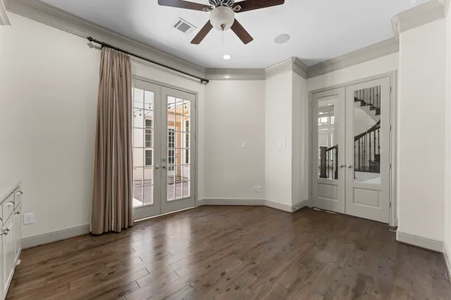 a view of empty room with ceiling fan