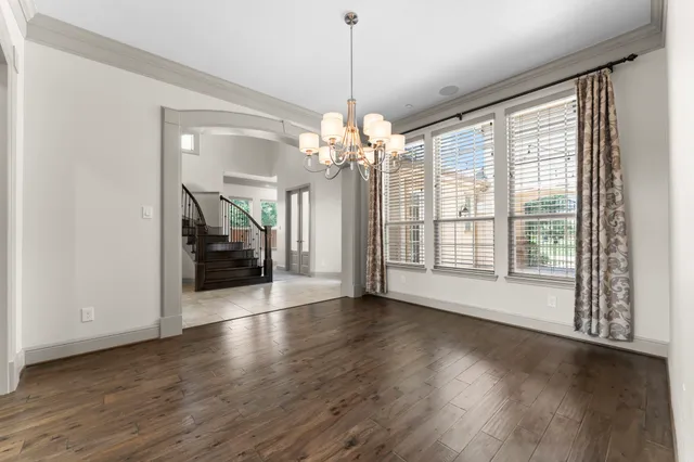 an entryway & a hallway with wooden floor