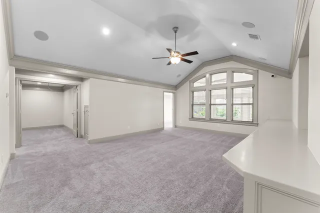a view of a livingroom with a ceiling fan and window