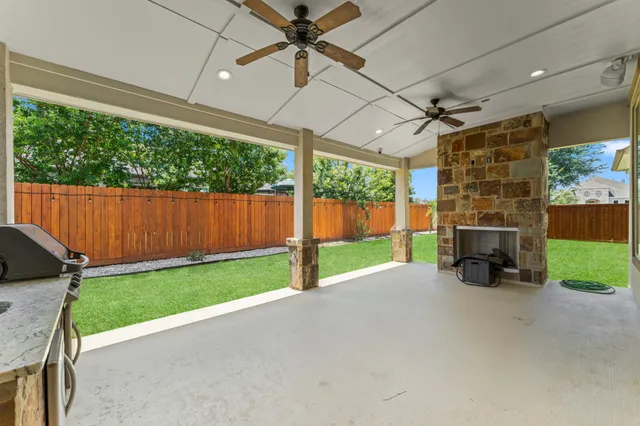 a view of a backyard with garden and outdoor seating