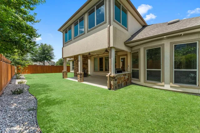 a view of an house with backyard porch and garden