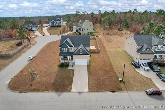 an aerial view of a house with a yard