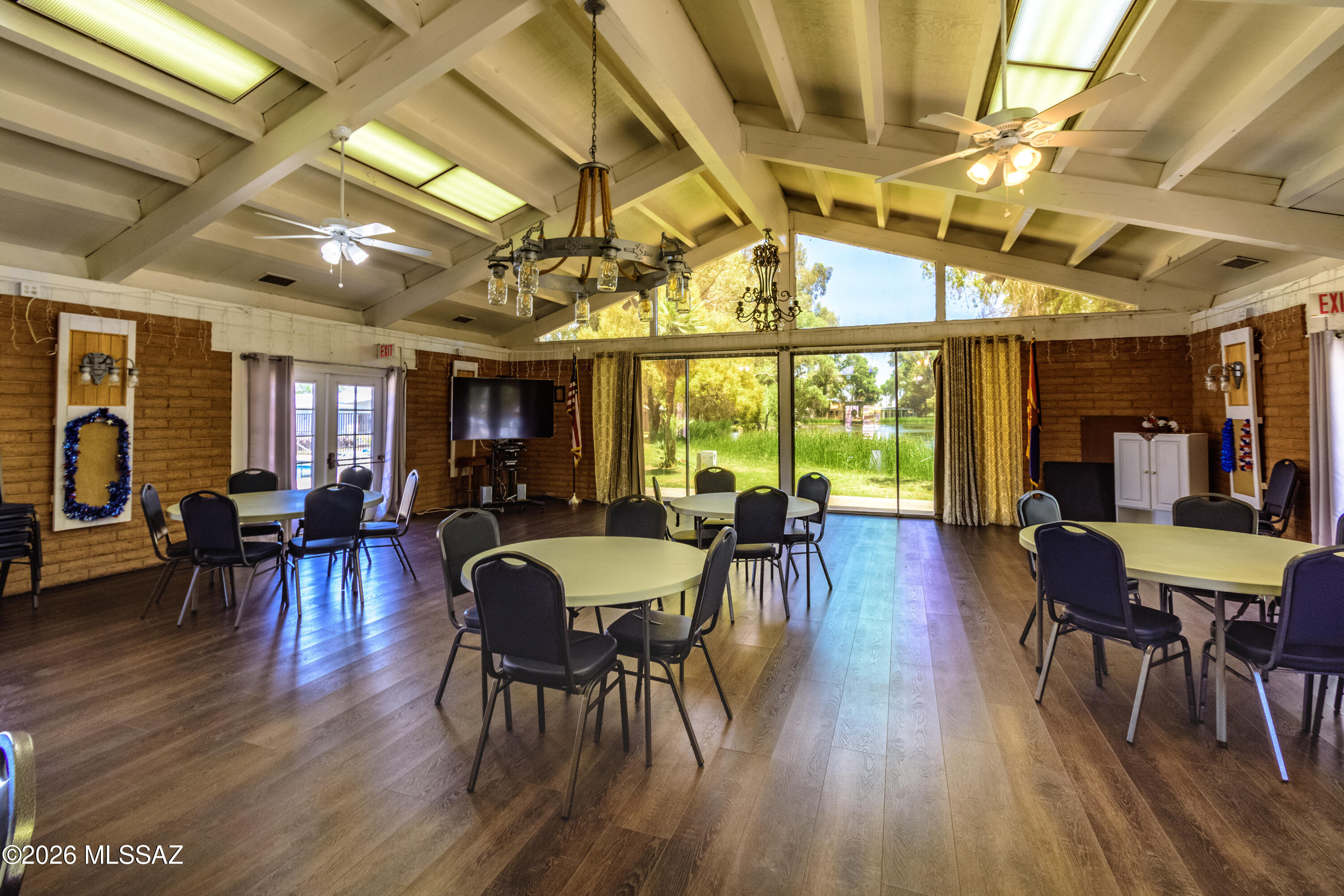 4550 North Flowing Wells Road, Unit 155 Tucson, AZ 85705 - Photo 31 of 40 a view of a dining room with furniture window and wooden floor
