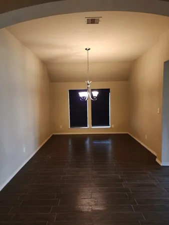 a view of a yard with wooden fence