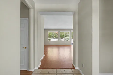 an entryway view with wooden floor and windows