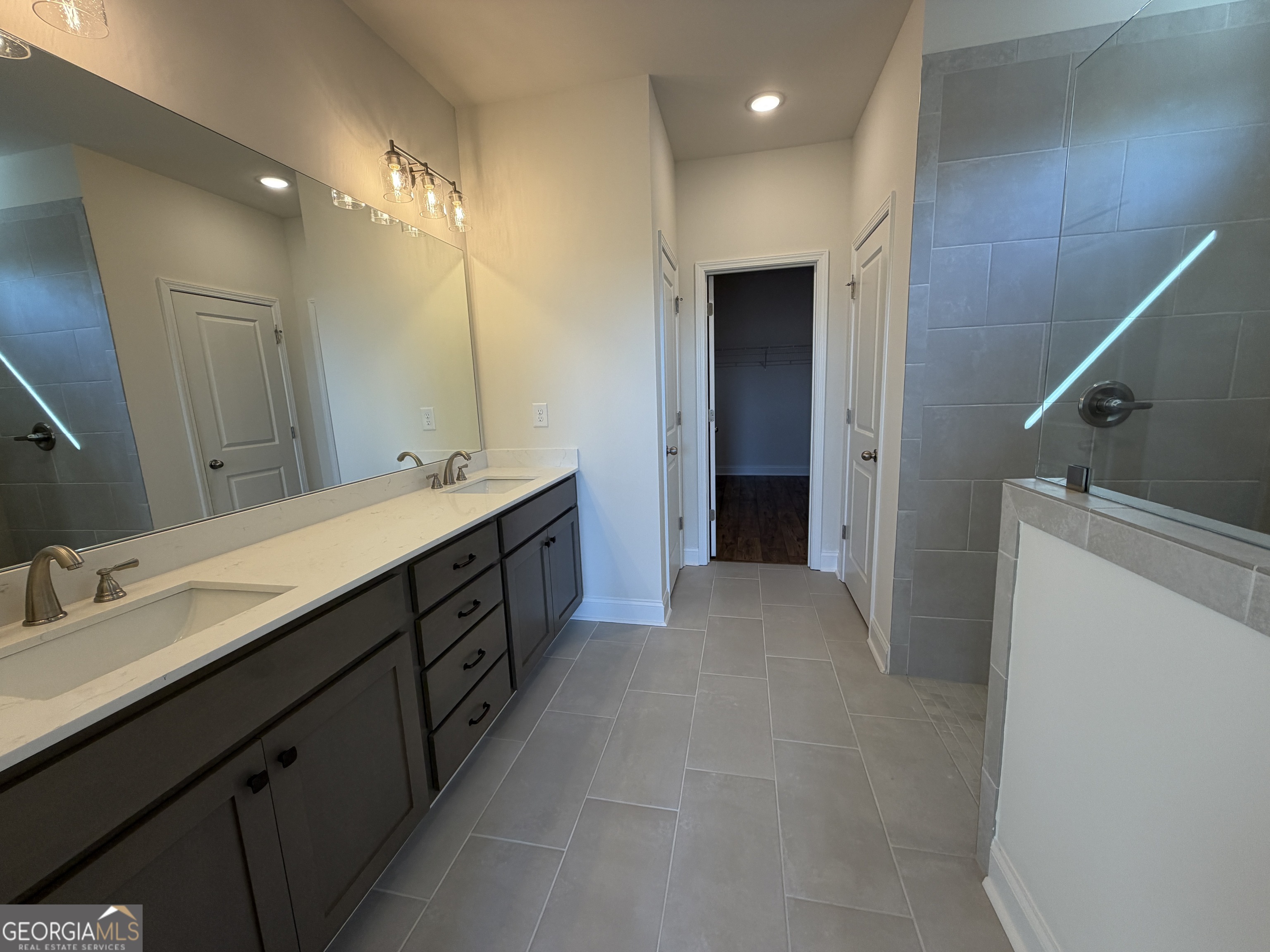 233 Oakdale Road, Unit 53 Jefferson, GA 30549 - Photo 27 of 64 Double vanity sinks, set at gentlemen's height & covered with quartz, 12 x 24 tiled floors, super shower, and separate linen & water closet