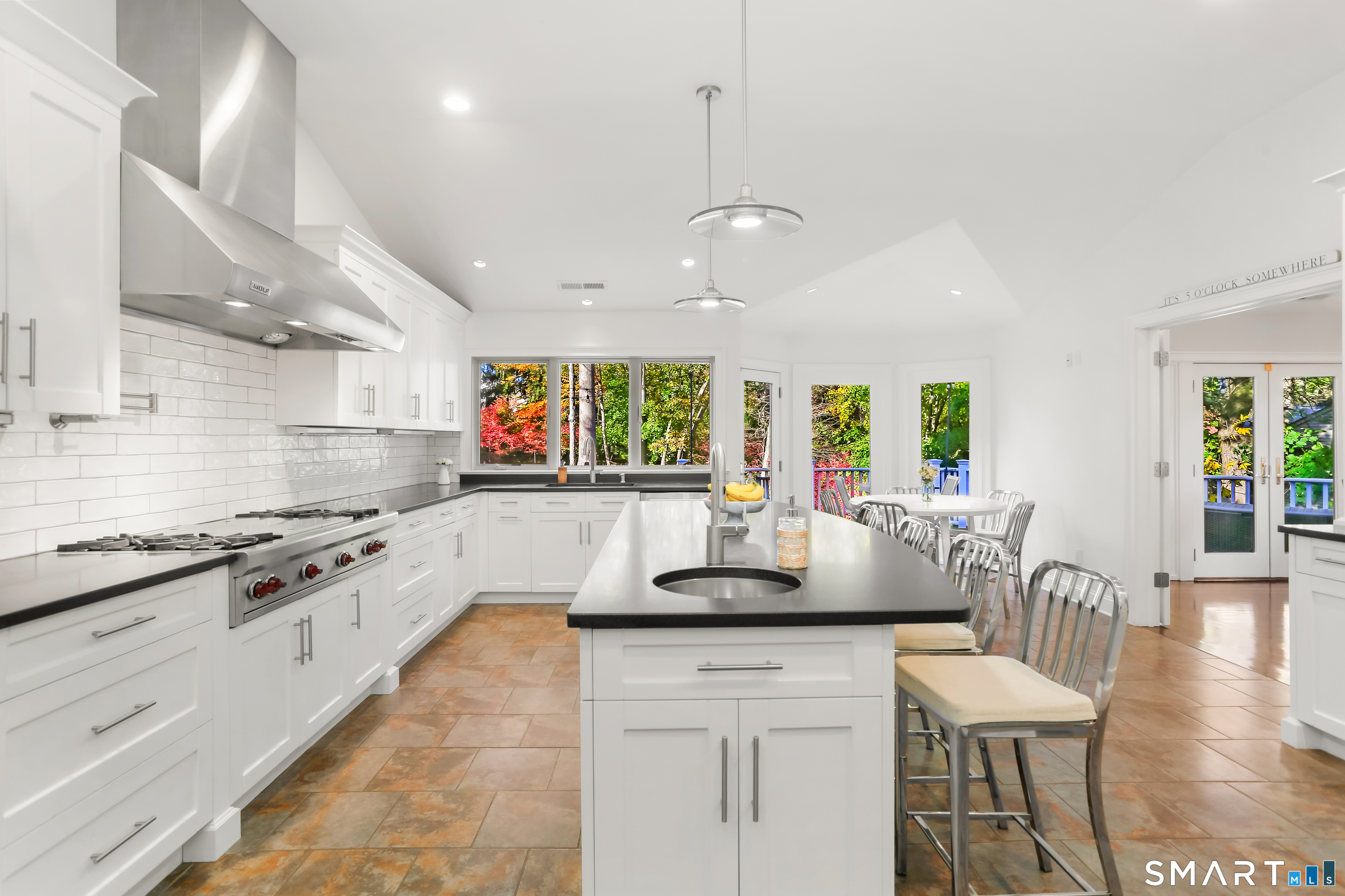1 Angora Road Westport, CT 06880 - Photo 8 of 39 a kitchen with stainless steel appliances granite countertop a stove a sink a dining table and chairs with wooden floor