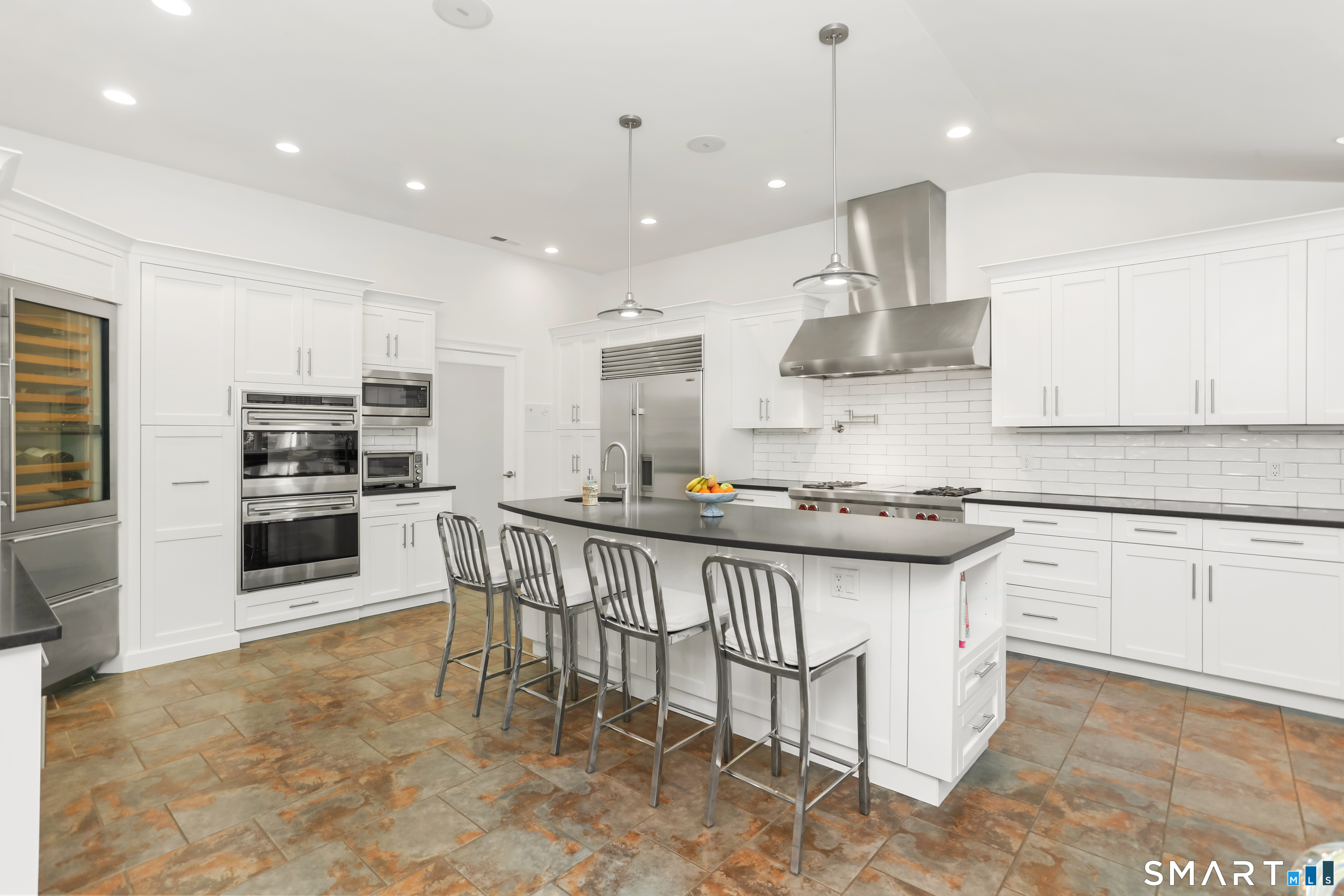 1 Angora Road Westport, CT 06880 - Photo 10 of 39 a kitchen with stainless steel appliances granite countertop a sink a stove a microwave a center island and cabinets